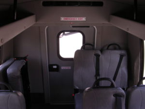 Interior of bus shown with some seating down.