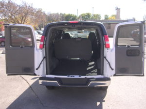 Shot from the outside of the rear interior of a fleet 8 passenger van.