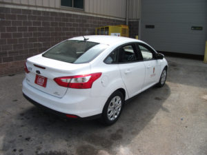 Image of the white fleet car's right side, shot from behind.