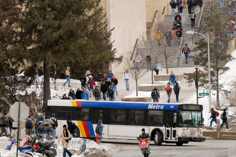 Pedestrians walk along Linden Drive as a Madison Metro Bus navigates the roadway Feb. 19, 2007 on the campus of UW-Madison.