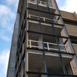 Shot from the ground looking up at the pedestrian stairwell tower. Glass has windows have not yet been installed.