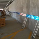 A collection of yet-to-be-installed parking wayfinding signage, including a "Parking to the right" and "Do Not Enter" signs.