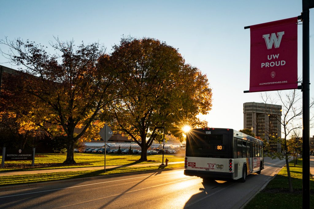 Campus bus route 80 travels down Linden Drive as the sun sets.