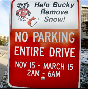 Photo of a winter parking sign which reads, "Help Bucky Remove Snow! No Parking Entire Drive, November 15 through March 15 from 2 am to 6 am"